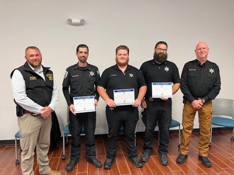 From left are Cherokee County Sheriff Dustin Smith, Corp. Christopher Baty, Officer John Downs Jr., Corp. Anthony Strickland and Major Montgomery Ward.