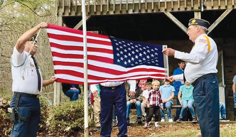 Photos by Randy Foster/editor@cherokeescout.com Members of American Legion Post 96 prepare to hoist a brand new U.S. flag after retiring the school’s old flat at Murphy Adventist Christian School on Monday.