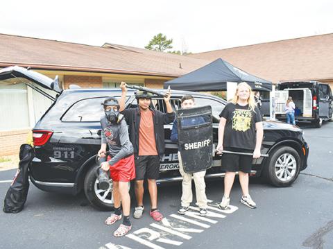 Photos by Anngee Quinones-Belian/Staff Correspondent Students were offered an opportunity to pick up tools of the trade with the Cherokee County Sheriff’s Office. The four young men value law enforcement officers. From left are Braylen Maennle, Christian Dejesus, Sebsiastian Jimenez and Ford Ashe.