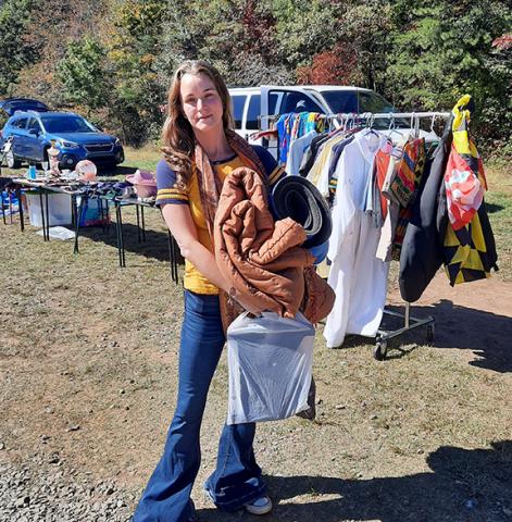 Photos by Anngee Quinones-Belian/Staff Correspondent  Sellers love customers like Heather Hickman of Murphy, who has been going to yard sales for most of her life. A future camping trip had her in search of a sleeping bag and other equipment. “It’s just gonna get dirty and stuff. I don’t wanna take my good stuff,” she said with a smile, adding, “and it’s fun.” She left with her arms full, and even found glass marbles for her nephew. 
