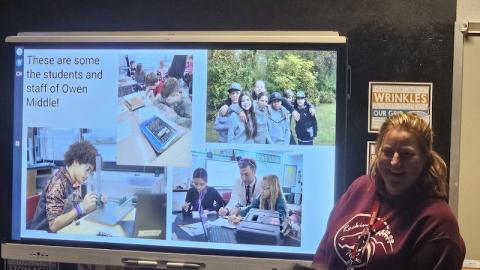 Nicole Wright/Staff Correspondent Nicole Phelps shows sixth-graders at Andrews Middle School a slideshow that includes a picture of her former classroom (bottom right) at her former school, Owen Middle School in Swannanoa. Andrews Middle students are writing letters to Owen Middle to offer encouragement in the wake of Hurricane Helene’s devastation of the area.