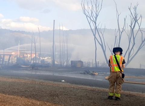 Anngee Quinones-Belian/Staff Correspondent A lone firefighter surveys the damage after a fire at Foster’s Flea Market in Ranger on Nov. 5 left an entire section of the sprawling facility in rubble and smoldering for days afterward.