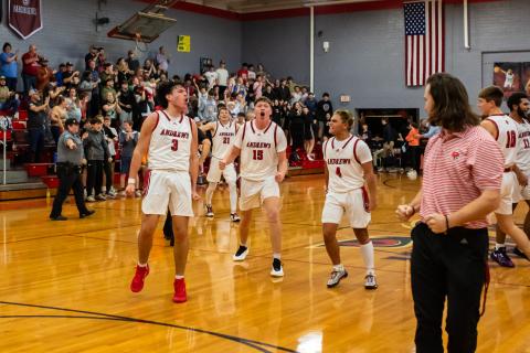 Cannon Crompton/sports@cherokeescout.com The Andrews Wildcats celebrate their win over Robbinsville on Dec. 17. From left are LaDannien Rattler, Braxton Rickett and Keegan Ellis.