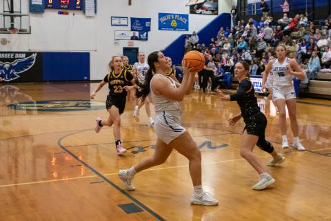 Cannon Crompton/sports@cherokeescout.com Brinkley Payne of Hiwassee Dam (left) drives to the hoop in their game against Murphy on Friday.