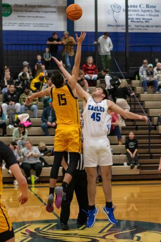 Cannon Crompton/sports@cherokeescout.com Abram Twiggs (left) of Murphy and Dalton Kester (right) of Hiwassee Dam go up for the tipoff on Friday night.