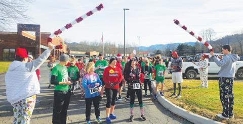 Photos by Nicole Wright/Staff Correspondent The crowd readies to begin Saturday morning’s first Jingle Bell Jog, sponsored by Andrews Middle School as a relief fundraiser for people in Swannanoa devastated by Hurricane Helene. The official Candy Caners are Alexis Beasley (left) and Jesus Jimenez. 
