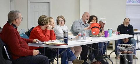 Randy Foster/editor@cherokeescout.com Cherokee County Republican Party Executive Committee Chair Dallas McMillan (center) picks a random question for applicants during a Q&A in Peachtree on Dec. 21.