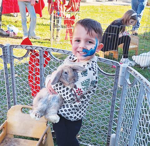 Gianni Nava of Murphy enjoys the petting zoo at the 11th annual Christmas on Main Street on Nov. 23.