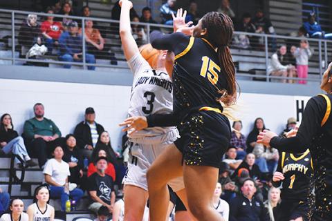 Bella Eddings/The Graham Star Patience Garrett of Murphy (right) delivers a resounding denial to Robbinsville’s Abby Wehr on Friday night.