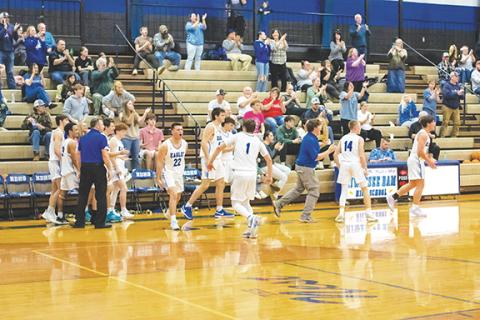 Cannon Crompton/sports@cherokeescout.com The Hiwassee Dam bench celebrates the Eagles’ 57-49 win over Hayesville on Dec. 9.