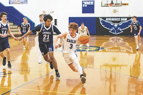 Cannon Crompton/sports@cherokeescout.com Abel Penland of Hiwassee Dam drives to the hoop past a Summit Charter defender in their game Friday.