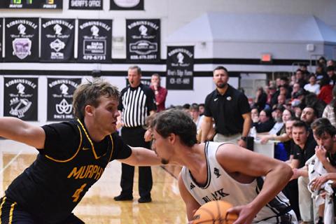 Kyla Garland/The Graham Star Aaron Harger of Murphy (left) defends during their game against Robbinsville on Friday. 