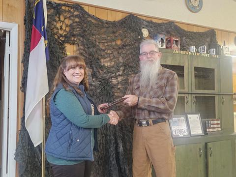 Nicole Wright/Staff Correspondent Andrews Veterans of Foreign Wars Post 7620 Commander Scott Ramler presents the group’s annual Teacher of the Year award to Andrews Middle School eighth-grade English language arts and social studies teacher Ann Williams at the Christmas celebration Saturday night.