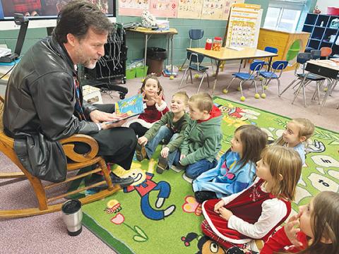 Cherokee Scout Publisher David Brown reads the book How to Catch An Elf on Dec. 13 to kindergarten students at Martins Creek Elementary School. A longtime reader on local school campuses, Brown oversees the Rotary Reads program for the Rotary Club of Murphy.