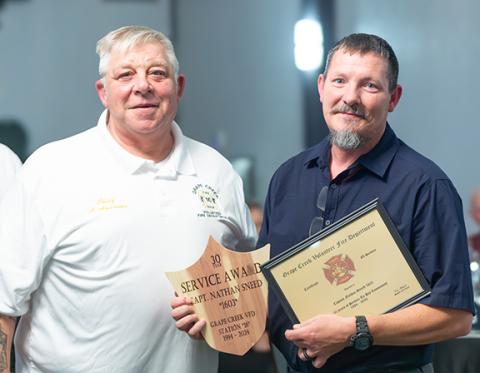 The Grape Creek Volunteer Fire Department held its Christmas dinner Saturday at The Ballroom in Murphy. Above: Capt. Nathan Sneed (right) is honored by Fire Chief Alan Andrews for 30 years of service. 