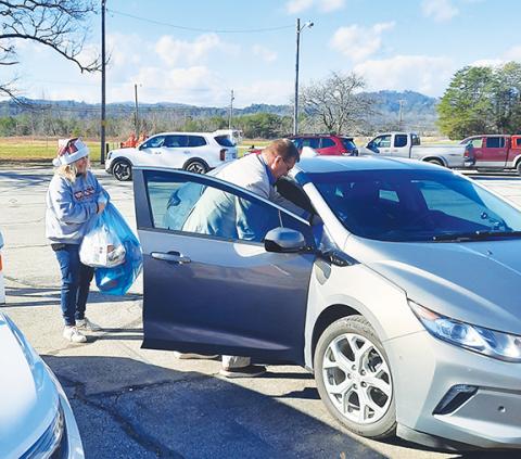 Photos by Anngee Quinones-Belian/Staff Correspondent  Jeana Conley (left), coordinator with Cherokee County Toys for Tots, and Murphy Mayor Tim Radford loaded up a vehicle with bags of toys to be taken to the Hurlburt Johnson Friendship House homeless shelter in Murphy. 