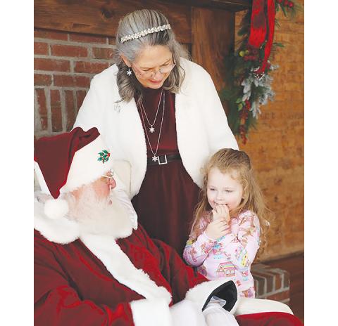 Laura Anderson/ North Georgia Media Phil and Dottie Close love children and were happy to hear Christmas requests from Everly Nicholson.