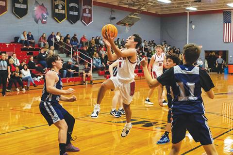 Cannon Crompton/sports@cherokeescout.com Eli Aguilar of Andrews jumps to get over the defenders and make a basket against Nantahala on Thursday. 