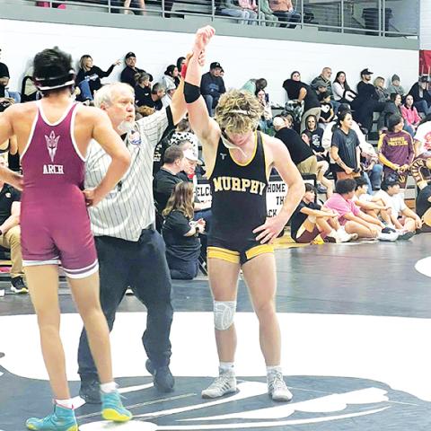 Cheryl Catuto/Contributing Photographer  Anthony Catuto of Murphy gets his hand raised after his win over James Arch of Swain County on Thursday.
