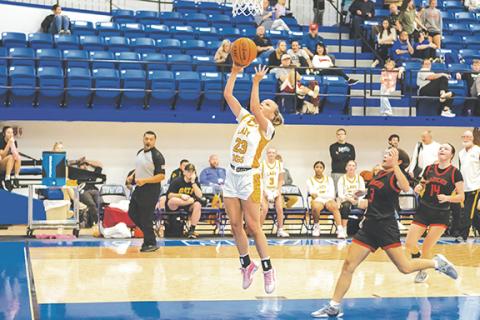 Cannon Crompton/sports@cherokeescout.com Lady Bulldog Emma Hensley jumps to make a layup in the third place game of the Battle of the States tournament in Hiawassee, Ga., on Dec. 30.