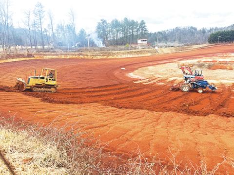 Kristie Oliver/Contributing Photographer A crew of volunteers begins track preparations at Tri-County Racetrack in Brasstown on Jan. 24 ahead of the first scheduled practice session on March 1. 