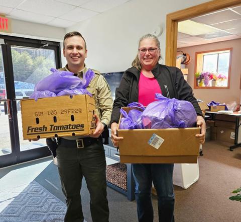 Cherokee County sheriff’s Deputy Hunter Wood helps deliver Code Purple bags to those who need it at the Hurlburt-Johnson Friendship House homeless shelter in Murphy.