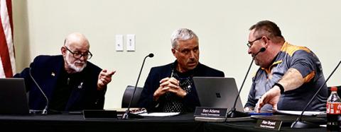 Randy Foster/editor@cherokeescout.com Commissioners Dan Eichenbaum, Mark Stiles and Ben Adams (from left) chat before the start of Monday night’s board of commissioners meeting.