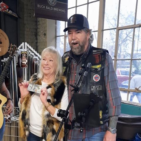 Photos by Anngee Quinones-Belian/ Staff Correspondent: A happy Mary Krebs was the first-place winner of the chili cook-off at Buck Bald Brewing in Murphy on Saturday sponsored by Nam Knights of America MC, Appalachian Chapter. She cheerfully gave the $100 bill back to the fundraiser as “Sig” Chris Poston hooted and hollered.
