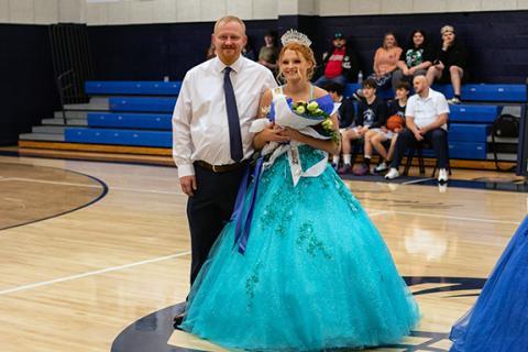 Cannon Crompton/sports@cherokeescout.com The 2025 Nantahala High School homecoming queen, Skyler Taylor (right) – accompanied by her escort, Josh Taylor – is all smiles after receiving her tiara and bouquet of flowers Thursday from last year’s homecoming queen, Fatima Villagomez. For the full court, see page 10A.