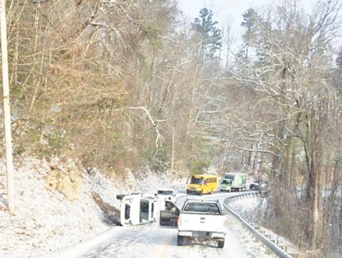 A Cherokee County Schools bus waits after a wreck occurred due to snowy conditions last week in Grape Creek. 
