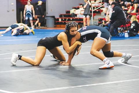 Cannon Crompton/sports@cherokeescout.com Smoky Mountain Conference 2024-25 champion Ivy Werner (left) fights for position looking for a pin against Julia Vazquez of Robbinsville.