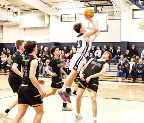 Cannon Crompton/ sports@cherokeescout.com Cole McCoy of Nantahala takes flight over a defender to score against Highlands on Thursday.