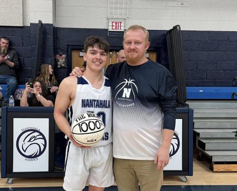 Nantahala junior Cole McCoy scored his 1,000th point of his high school career on Jan. 17 at Hayesville. On Jan. 21, McCoy (left) was given the game ball by head coach Josh Taylor (right).