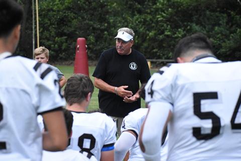 Kevin Hensley/The Graham Star Dee Walsh, the now former head coach of the Robbinsville Black Knight football team, talks to his players. 