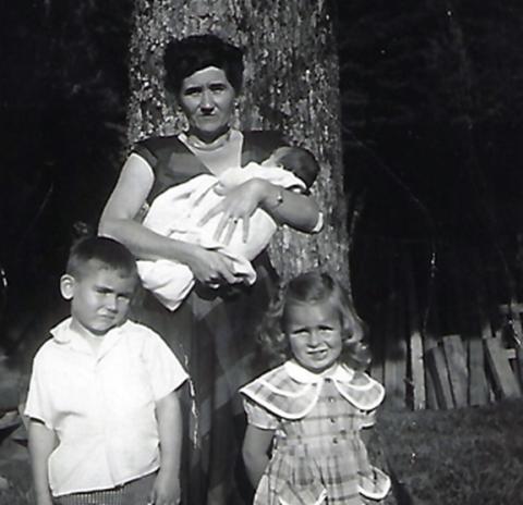 Dana Jones (left) is shown with his beloved “Granny,” Anna Lenora, who is holding his sister, Della Tatham, and his little friend Diane Mintz (right).