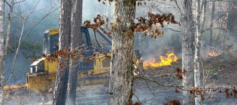 A U.S. Forest Service bulldozer cuts through a fire line near Grape Creek on March 19. High winds made it a tougher day. Randy Foster/editor@cherokeescout.com