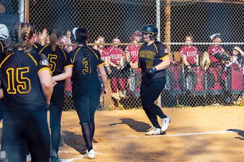 Cannon Crompton/sports@cherokeescout.com Murphy softball player Gracie Thrasher comes across home plate surrounded by her teammates after hitting a home run against Tellico Plain, Tenn., on March 11. 