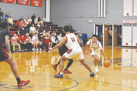 Bre Woodard/Staff Correspondent  Kegan Ellis (right) of Andrews drives to the hoop while Landon Greene (left) sets a screen in their game against Winston-Salem Prep on Feb. 25. 