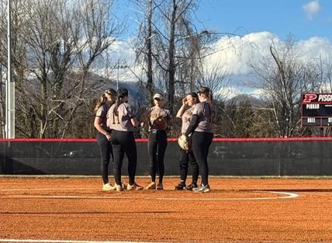 Kristie Oliver/Contributing Photographer Murphy varsity softball players gather on the pitchers mound before their game against Pisgah on Feb. 27.
