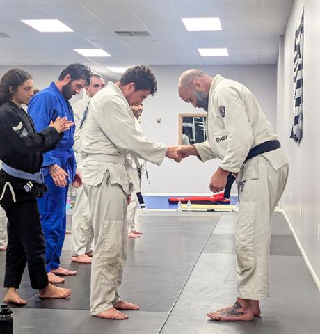 Family Brazilian Jiujitsu Center Will Wimpey (left) earns a stripe on his white belt from Professor Vincent Werner (right) at the Murphy Family Brazilian Jiujitsu Center.