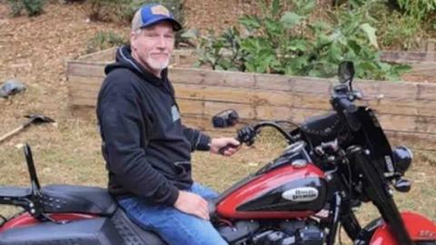 Ronald McClenny is shown on his motorcycle in this undated family photo.