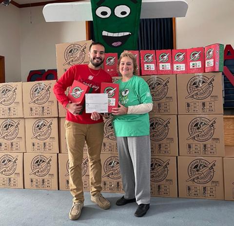 Cody Rodgers (left), Mountain Credit Union manager, presents a donation of $1,150 to June Trull, area team coordinator for Operation Christmas Child, during Collection Week. The donation will be applied to the distribution costs of shoeboxes. 