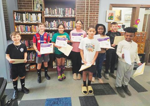 Nicole Wright/Staff Correspondent Winners of the fifth annual Purel Miller African-American Reading Challenge gathered to claim their awards Thursday at the Andrews Public Library. From left are Caleb Spatola, Jacob Spatola, Krislynn White, Cataleya Greene, Lincoln Greene, Natalie George, Levi Shamblin and Eli George. 
