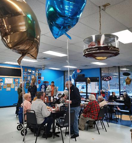 Photos by Anngee Quinones-Belian/Staff Correspondent  Rotary International celebrated 120 years with local Rotarians and their guests on Feb. 27 at Pop's Mountaintop Ice Cream & Shipping in Murphy. Folks enjoyed a meal, a birthday cake and ice cream while playing a variety of games.