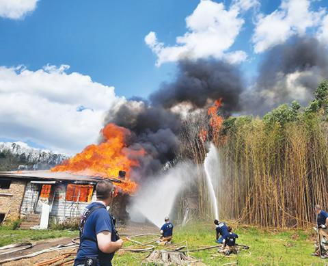 Photos by Anngee Quinones-Belian/Staff Correspondent A vacant house in Murphy became a virtual hot-spot Saturday afternoon, giving firefighters and students a real-life training scenario. Fire from the training exercise unintentionally spread to a wooded area featuring bamboo.