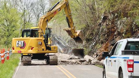 Randy Foster/ editor@cherokeescout.com An N.C. Department of Transportation crew clears Airport Road just west of Marble on Friday afternoon following a rock slide.