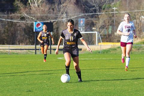 Cannon Crompton/sports@cherokeescout.com Brooklyn Johnson of Murphy takes the ball down the pitch against Swain County on March 24.