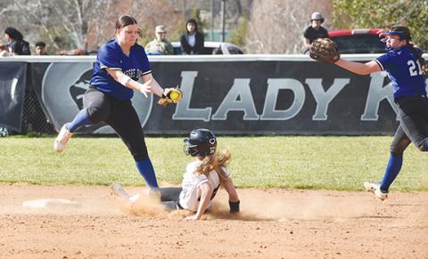 April McNabb/Contributing Photographer  Sky Taylor of Hiwassee Dam gets the ball to tag out a Robbinsville player during their game March 25.