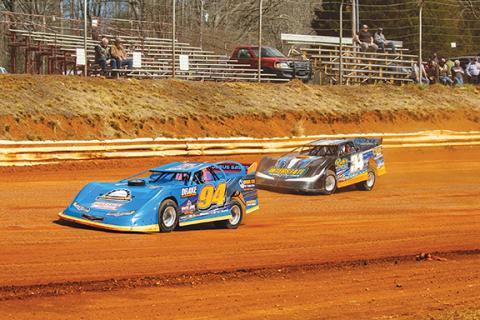 Cannon Crompton/sports@cherokeescout.com Two cars fly down the pit side straight at Tri-County Racetrack in Brasstown at their second practice on March 8.
