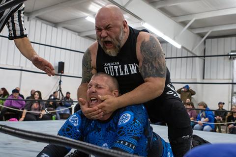 Cannon Crompton/sports@cherokeescout.com Killshot (top) chokes Stryker in their match at the ACWF’s January show. 